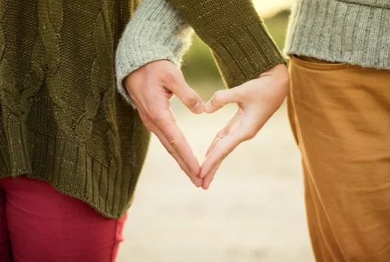 Hands forming a heart; our mission to help people connect